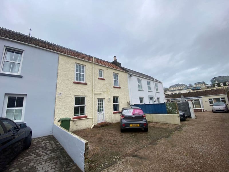 Cream-painted two-bedroom cottage in a small cul-de-sac off Springfield road